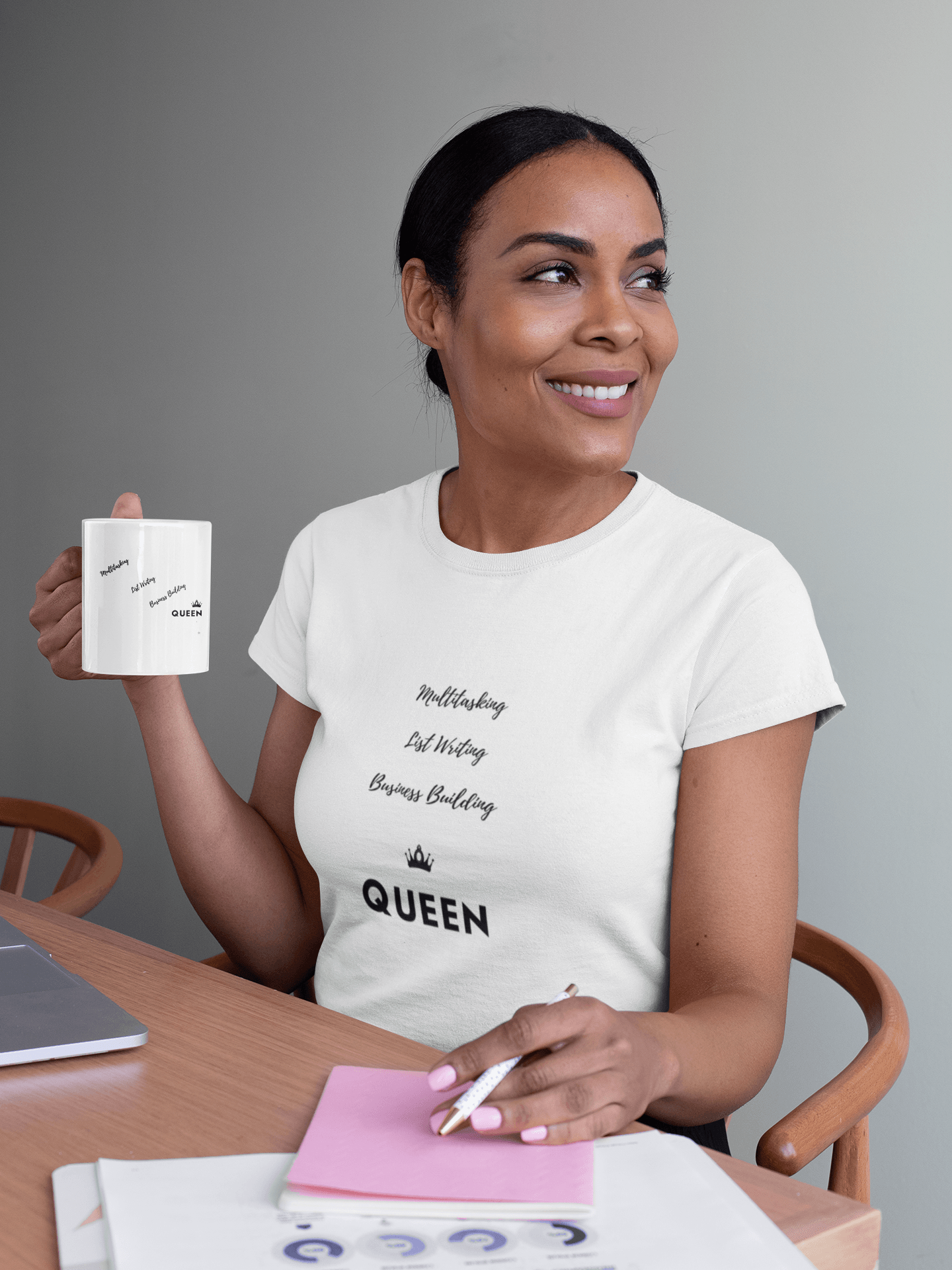 CP Designs Unlimited - African American woman wearing Business Building Queen tee and holding matching mug